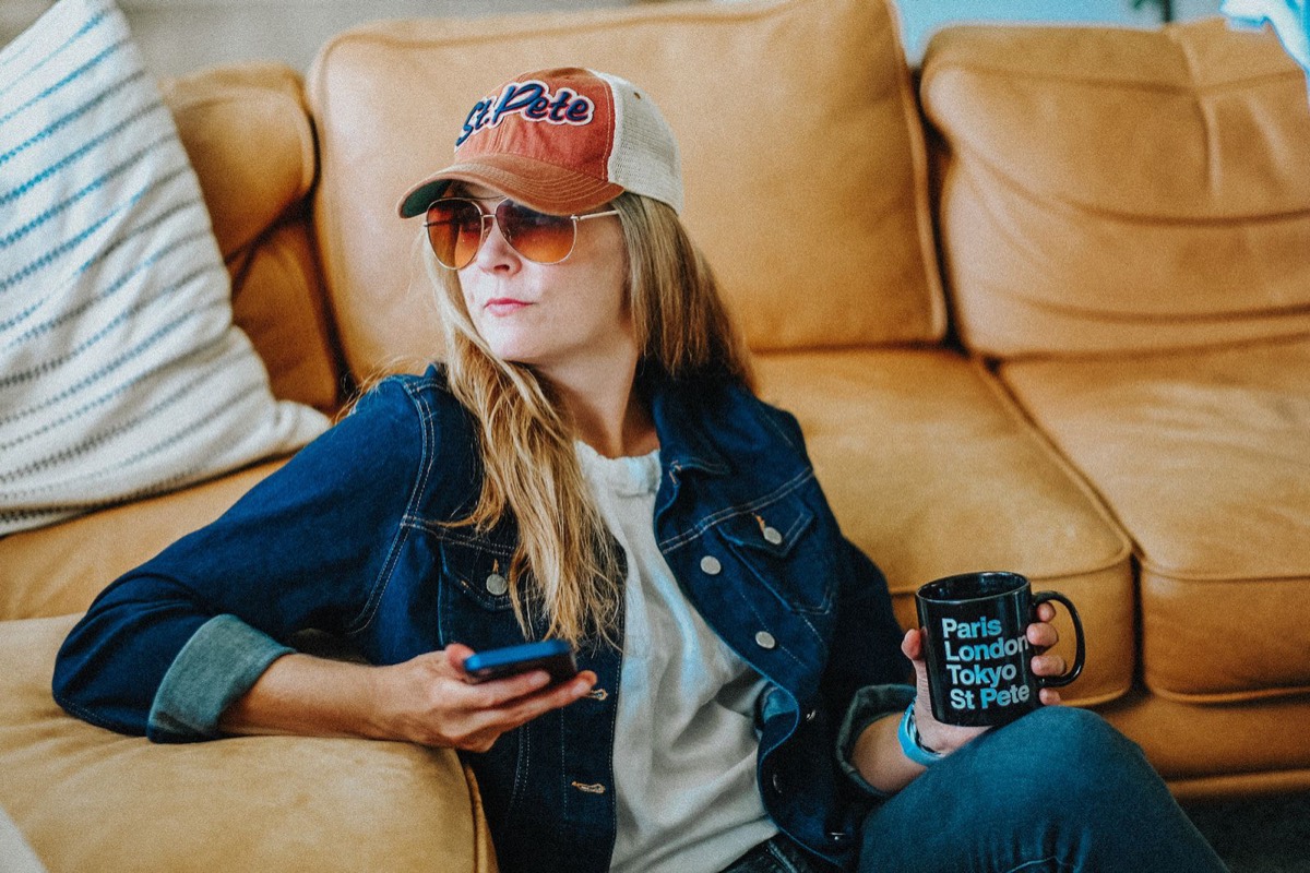 Erika Stanley, founder of Mile End Digital, on a leather couch in a St Pete cap